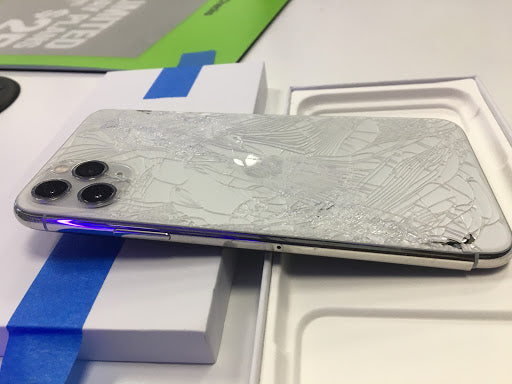 Damaged smartphone on a white surface with a blue stripe