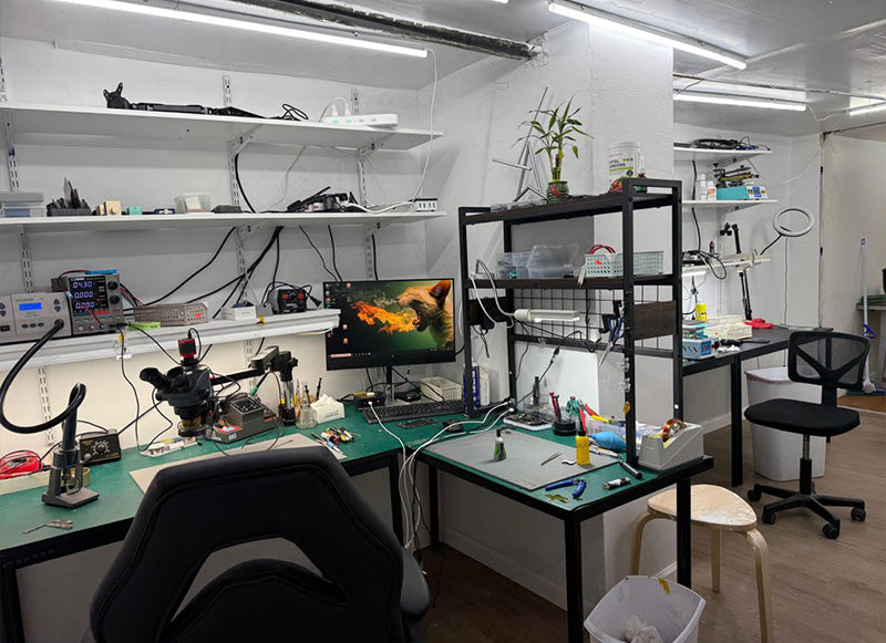 Laboratory or workshop setup with equipment and a computer monitor displaying a fish image.