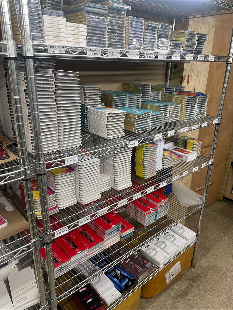 Metal shelving unit with various stationery items in a storage room.