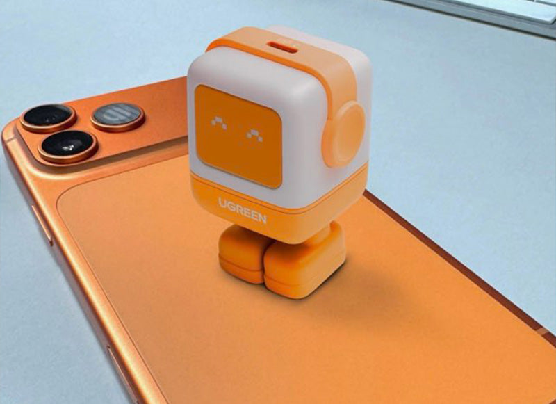 Small robot toy on an orange smartphone with a light blue background