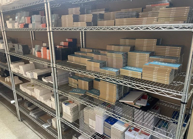 Metal shelving unit with stacked boxes and packages in a warehouse setting